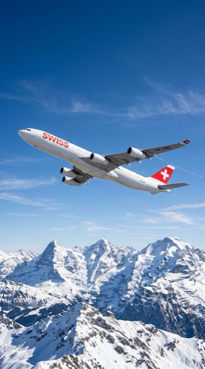 A Swiss airliner climbing over the snow-covered Alps