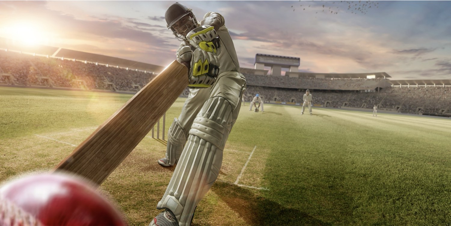 A batter driving through the off side, ball in the foreground